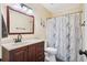 Full bathroom features an updated vanity with mirror, and a shower with blue patterned curtain at 404 Terrier Rd, Goose Creek, SC 29445