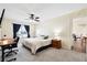 Bright bedroom featuring neutral walls, soft carpet, ceiling fan, and wooden desk with natural light streaming from the window at 404 Terrier Rd, Goose Creek, SC 29445