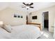 Comfortable bedroom featuring neutral walls, soft carpet, ceiling fan, and a view into the ensuite bathroom at 404 Terrier Rd, Goose Creek, SC 29445