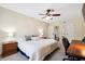 Comfortable bedroom featuring neutral walls, soft carpet, ceiling fan, and a view into the ensuite bathroom at 404 Terrier Rd, Goose Creek, SC 29445