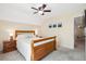Comfortable bedroom featuring neutral walls, soft carpet, ceiling fan, and wood furniture at 404 Terrier Rd, Goose Creek, SC 29445