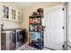 Well-organized laundry room equipped with a modern washer and dryer, storage cabinets, and door to the outside at 404 Terrier Rd, Goose Creek, SC 29445