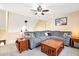 Inviting living room with a large sectional couch, ceiling fan, and wood accents at 404 Terrier Rd, Goose Creek, SC 29445