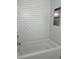 Bright white shower and tub with white tiled wall niche for storage at 415 Parkdale Dr # 12 A, Charleston, SC 29414