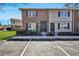 Charming townhome featuring a brick facade, black shutters, and convenient parking at 415 Parkdale Dr # 12 A, Charleston, SC 29414