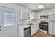 Updated kitchen features white cabinets, stainless steel appliances, and modern lighting at 415 Parkdale Dr # 12 A, Charleston, SC 29414