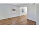 Cozy living room with wood-look floors, natural light from a window, and freshly painted white walls at 415 Parkdale Dr # 12 A, Charleston, SC 29414