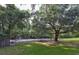 Community playground features a swing set, a slide, and mature shade trees at 415 Parkdale Dr # 12 A, Charleston, SC 29414