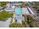 An aerial view of a community pool with lounge chairs, palm trees, and nearby homes at 4341 Cordial Aly, North Charleston, SC 29405