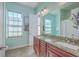Bathroom features a dual sink vanity with granite countertops, a large mirror, and light-blue walls at 4341 Cordial Aly, North Charleston, SC 29405
