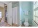 Bathroom with toilet, stacked washer and dryer visible through door, and bright light at 4341 Cordial Aly, North Charleston, SC 29405