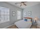 Charming bedroom featuring a ceiling fan, neutral walls, and two sunlit windows with blinds at 4341 Cordial Aly, North Charleston, SC 29405