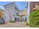 View of the home's exterior featuring garages and a quaint courtyard at 4341 Cordial Aly, North Charleston, SC 29405