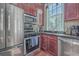 Kitchen featuring stainless steel appliances, dark wood cabinets, and granite countertops at 4341 Cordial Aly, North Charleston, SC 29405