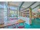 Bright market interior featuring shelving, large windows, and tables with pink chairs at 4341 Cordial Aly, North Charleston, SC 29405