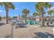 Inviting patio area with ample seating surrounded by palm trees and umbrellas at 4341 Cordial Aly, North Charleston, SC 29405