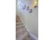 Carpeted staircase with decorative wall art and modern lighting at 4341 Cordial Aly, North Charleston, SC 29405