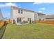 Spacious backyard featuring a patio set for outdoor dining, a well-maintained lawn, and a privacy fence for added seclusion at 4497 Ocean Farm Dr, Summerville, SC 29485