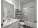 Bright bathroom featuring a shower-tub combo, granite vanity top, and decorative shelving for towels and toiletries at 4497 Ocean Farm Dr, Summerville, SC 29485