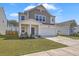 Charming two-story home with front porch, attached two-car garage, and fresh landscaping at 4497 Ocean Farm Dr, Summerville, SC 29485