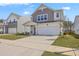 Charming two-story home featuring a two-car garage and manicured front lawn at 4497 Ocean Farm Dr, Summerville, SC 29485