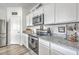 Well-lit kitchen featuring stainless steel appliances, granite countertops, and white cabinets at 4497 Ocean Farm Dr, Summerville, SC 29485