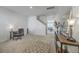 Spacious living room with neutral carpet, stairway view, a desk, and decorative console table at 4497 Ocean Farm Dr, Summerville, SC 29485