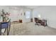 Inviting living room featuring a desk, patterned carpet, decorative console table, and front door at 4497 Ocean Farm Dr, Summerville, SC 29485