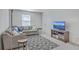 Well-lit living room showcases a comfortable sofa, rug, TV, and side tables at 4497 Ocean Farm Dr, Summerville, SC 29485