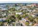 Aerial view showcasing a house surrounded by lush greenery, with a glimpse of a body of water and the skyline at 51 Gadsden St # B, Charleston, SC 29401