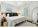 Bright bedroom with a large bed, ceiling fan, and natural light from two windows at 51 Gadsden St # B, Charleston, SC 29401