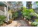Charming brick courtyard with wooden planters and stairs leading to upper levels, surrounded by lush greenery at 51 Gadsden St # B, Charleston, SC 29401