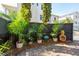 Private brick courtyard with lush tropical landscaping and ornamental features creating a peaceful outdoor space at 51 Gadsden St # B, Charleston, SC 29401