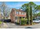 Charming brick home with a red roof, complemented by lush landscaping, a white car, and inviting curb appeal at 51 Gadsden St # B, Charleston, SC 29401