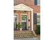 Inviting front entrance with a wreath, stylish lighting, and well-maintained brick facade at 51 Gadsden St # B, Charleston, SC 29401