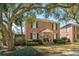 Beautiful two-story brick home with mature trees, tidy landscaping, and classic architectural details at 51 Gadsden St # B, Charleston, SC 29401