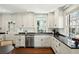 Bright kitchen featuring white cabinets, black countertops, stainless steel appliances and hardwood floors at 51 Gadsden St # B, Charleston, SC 29401