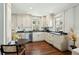 Bright kitchen features white cabinetry, stainless steel appliances, and a round table with seating at 51 Gadsden St # B, Charleston, SC 29401