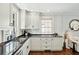 Bright kitchen with white cabinetry, black countertops, and stainless steel appliances at 51 Gadsden St # B, Charleston, SC 29401