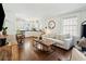 Sunlit living room featuring modern furnishings, hardwood floors, and seamless flow to the kitchen at 51 Gadsden St # B, Charleston, SC 29401