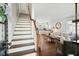 Bright entryway showcases stairs, wood floors and an open floor plan into the living and kitchen area at 51 Gadsden St # B, Charleston, SC 29401