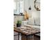 Living room with a couch, ottoman, and access to the modern, bright kitchen space at 51 Gadsden St # B, Charleston, SC 29401