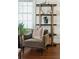 Comfortable olive armchair with wooden floors and decorative shelves at 51 Gadsden St # B, Charleston, SC 29401