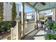 Cozy porch with seating area, ceiling fan, and view of the surrounding neighborhood and beautiful plants at 51 Gadsden St # B, Charleston, SC 29401