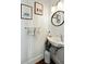 Charming powder room with a pedestal sink, round mirror, and stylish decor at 51 Gadsden St # B, Charleston, SC 29401