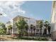 Beautiful exterior of condos surrounded by palm trees and lush landscape, with covered balconies at 540 Helmsman St # 1235, Daniel Island, SC 29492