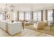 Open concept living and kitchen area with natural light, white walls, and hardwood floors at 540 Helmsman St # 1235, Daniel Island, SC 29492