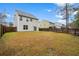 Spacious backyard featuring a wood fence, lush grass and a patio area at 558 Wynfield Forest Dr, Summerville, SC 29485