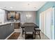 Stylish dining area with dark wood table, chairs, and modern chandelier next to the open kitchen at 558 Wynfield Forest Dr, Summerville, SC 29485