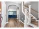 Inviting entryway featuring hardwood floors, staircase, and an arched doorway leading to the living area at 558 Wynfield Forest Dr, Summerville, SC 29485